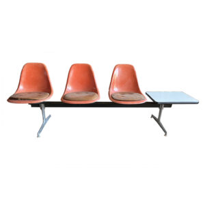 Tandem with Three Orange Shells and Light Brown Cushions and White Table Top by Charles and Ray Eames